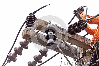 Rural electric poles are being repaired by electricians installing wires to connect. The tops of the electric poles are attached Stock Photo