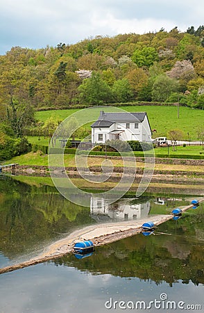 Rural german landscape with a house near the river Stock Photo