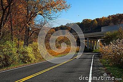 A rural highway and a freeway overpass in autumn Stock Photo