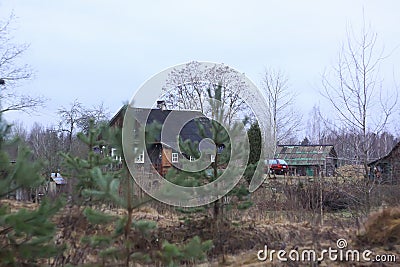 Rural house building, trees and stork`s nest in autumn day Stock Photo