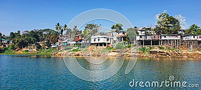 Rural house on silts hill tribe settlements along the coastline of Kaptai lake Stock Photo