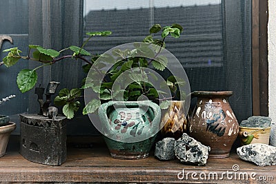 Rural house window and old jugs, clay pots and iron Stock Photo