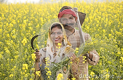 Rural Indian couple farming in agricultural field Stock Photo
