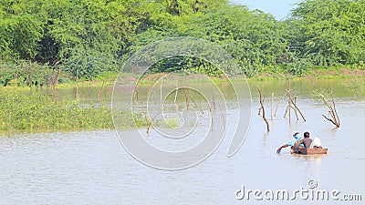 A rural landscape in india, people crossing river Editorial Stock Photo