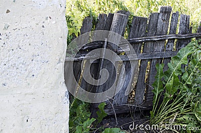 Rural life, old wooden skewed collapsing fence protects the private territory Stock Photo