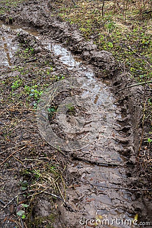 Rural muddy dirt road in early spring after rain. Off-road Stock Photo