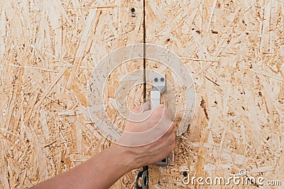 Rural old door of sawdust. a man opens a wooden door. Stock Photo