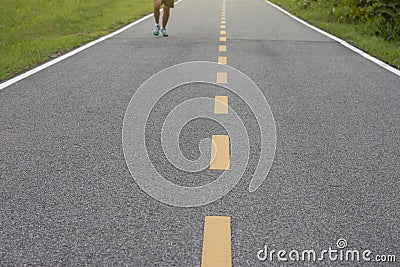 Rural paved roads with nature on either side and the sunlight in the evening. Stock Photo