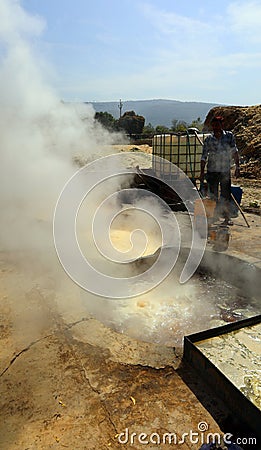 Man working in a factory boiling sugar cane. Editorial Stock Photo