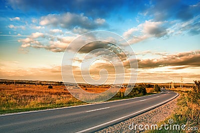 Rural road and blue sky with clouds Stock Photo