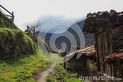 rural road towards the mountains Stock Photo