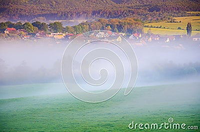 Rural village in calm spring morning covered in mist Stock Photo