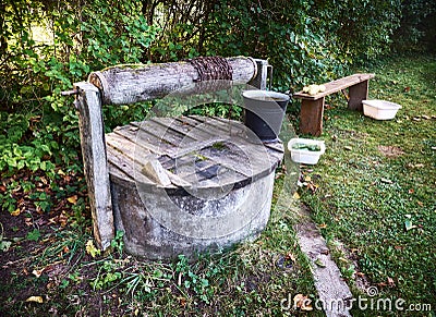 Rural well with bucket Stock Photo