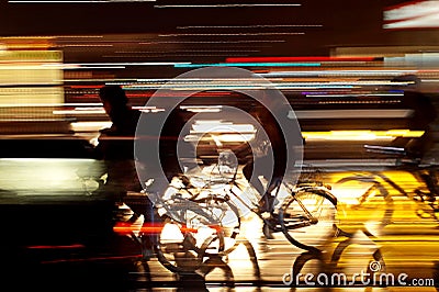 Rushhour with cyclists at night Stock Photo