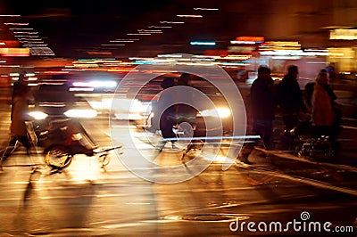 Rushhour with cyclists and pedestrians at night Stock Photo