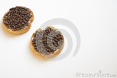 Rusk with chocolate hail, Dutch Hagelslag, on white table. Space for text Stock Photo