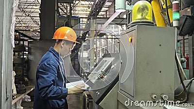 RUSSIA, ANGARSK - JUNE 8, 2018: Operator monitors control panel of production line. Manufacture of plastic water pipes Editorial Stock Photo