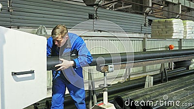 RUSSIA, ANGARSK - JUNE 8, 2018: Sawmill circular saw machine. Manufacture of plastic water pipes factory. Process of Editorial Stock Photo