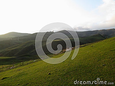 Russia, Caucasia, Ingushetia. Green mountain on blue sky background, horizontal view. Stock Photo