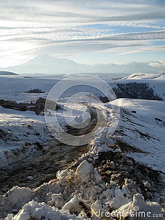 Russia, Caucasia. Road and snow on mountain and blue sky background, vertical view. Stock Photo