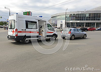Russia, Chelyabinsk, 08/20/2020 An ambulance car with open doors is on a city street on a city street, and the car is receiving me Editorial Stock Photo