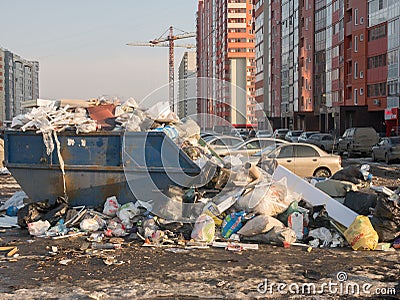 Russia, Chelyabinsk 03/10/2020 Garbage container overflowing in a busy area of the city Editorial Stock Photo