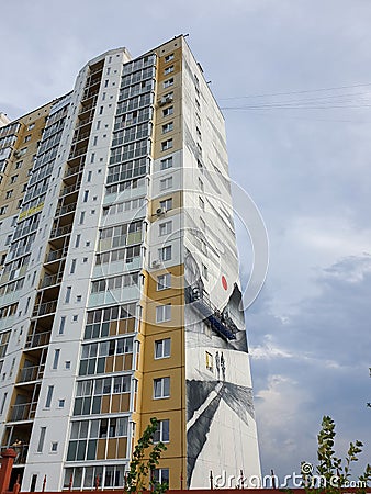 Russia, Chelyabinsk 08/03/2020 View of a house in a modern district of the city. On the wall, artists paint a picture, Editorial Stock Photo