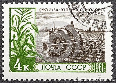 RUSSIA - CIRCA 1961: Postage stamp printed in Soviet Union Russia shows man planting corn, For an Abundance of Farm Editorial Stock Photo