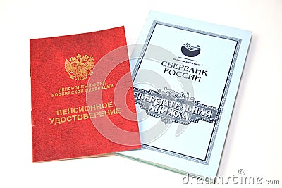 Pension card and savings book of Sberbank of Russia on a white background. Russian text - pension Editorial Stock Photo