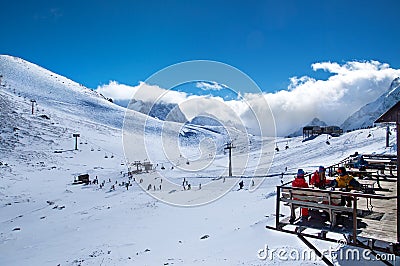 Russia, Dombai-February 7, 2017: Beautiful view of Ski resort high in the mountain. Group Of Friends Enjoying Hot Drink Editorial Stock Photo