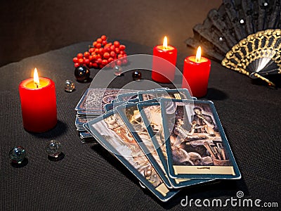 Russia, Dzerzhinsk, October 09, 2021. Cartomancy, fortune telling, predictions on Tarot cards. Magical objects, candles Editorial Stock Photo