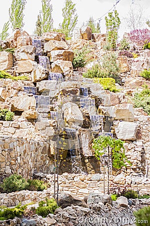 2021-05-07. Russia. Kamensk-Shakhtinsky, Rostov region. Beautiful decor elements in the park for tourists. Waterfall among the Editorial Stock Photo