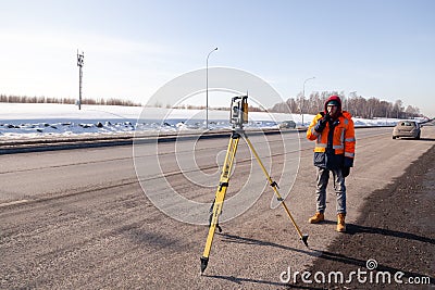 Russia Kemerovo 2019-03-15. Land and construction surveyor equipment. Geodesist controls robotic total station theodolite. Editorial Stock Photo
