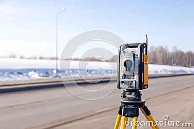 Russia Kemerovo 2019-03-15. Land surveyor equipment. Robotic total station theodolite standing on tripod. Equipment used for Editorial Stock Photo