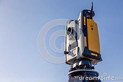 Russia Kemerovo 2019-03-15. Land surveyor equipment. Robotic total station theodolite standing on tripod. Equipment used for Editorial Stock Photo