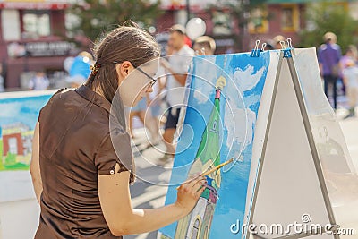 RUSSIA, Krasnoyarsk - August 25: A girl draws on a paper Orthodox chapel Paraskeva Pyatnitsa on top of Karaulnaya mountain, a Editorial Stock Photo