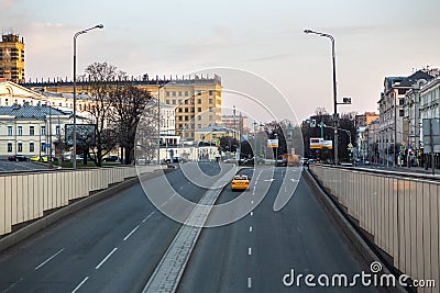 Russia, Moscow, April 2020. Empty streets of the city. Quarantine in Moscow. Rare passers-by in disposable masks, rare cars. City Editorial Stock Photo