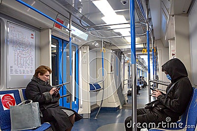 Russia, Moscow, April 2020. An empty subway car. Quarantine in Moscow. People in disposable masks Editorial Stock Photo