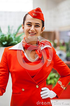 RUSSIA, MOSCOW: 01 AUGUST 2019. Beautiful stewardess dressed in official red uniform Aeroflot Airlines Editorial Stock Photo