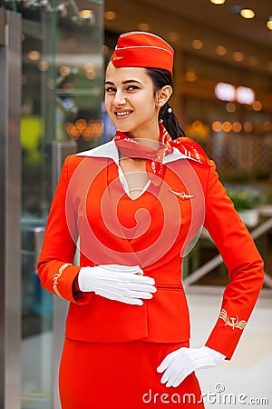 RUSSIA, MOSCOW: 01 AUGUST 2019. Beautiful stewardess dressed in official red uniform Aeroflot Airlines Editorial Stock Photo