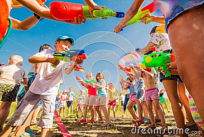 Russia. Moscow. August 11, 2018 Children playing outdoors with water cannons on a beautiful sunny day Editorial Stock Photo