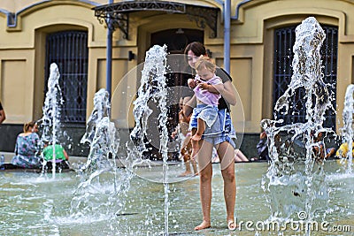 Russia, Moscow, August 4, 2018, mother and child play in the fountain, editorial Editorial Stock Photo