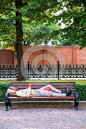 Homeless on street bench Editorial Stock Photo