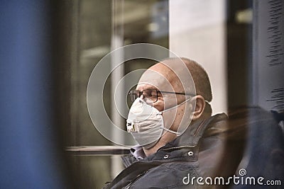 Russia Moscow June 2020. Moscow metro. a man in a protective mask rides in a subway car. view from the next car. coronavirus Editorial Stock Photo