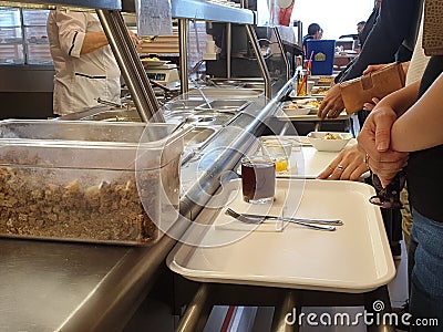 Russia, Moscow, May 2019. Communal dining room. Public eatery. Office workers pick food Editorial Stock Photo