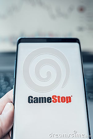 Russia Moscow 02.02.21 Mobile phone with logo of Gamestop in hand. Company making video games. Playing on trading exchange,price, Editorial Stock Photo