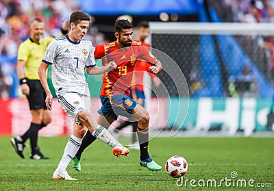 Russia national football team midfielder Daler Kuzyaev against Spain striker Diego Costa during FIFA World Cup 2018 Round of 16 Editorial Stock Photo