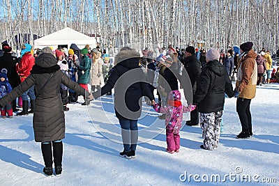 cheerful people parents and children hold hands on a traditional Russian holiday dancing in a Editorial Stock Photo