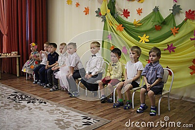 children sit on chairs in kindergarten boys and girls Editorial Stock Photo