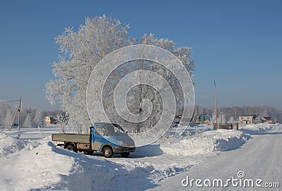 frosty winter in Siberia truck stuck in the snow rural climate Editorial Stock Photo
